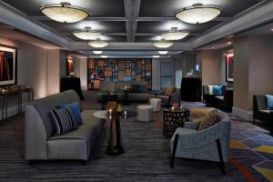 a lobby with couches and chairs and a library at Renaissance Providence Downtown Hotel in Providence