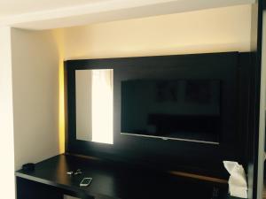 a bathroom with a mirror and a black counter at Park Srce Apartments in Arandelovac