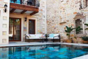 a swimming pool in front of a house at Sinem Hanım Konağı Boutique Hotel in Yenifoça