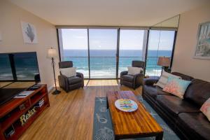 a living room with a view of the ocean at Capri Beach Accommodations at Capri By The Sea in San Diego