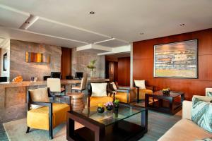 a lobby with couches and chairs and a bar at Sheraton Grand Beijing Dongcheng Hotel in Beijing