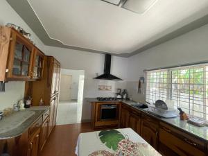 a kitchen with wooden cabinets and a counter top at The Retreat in Lyssons