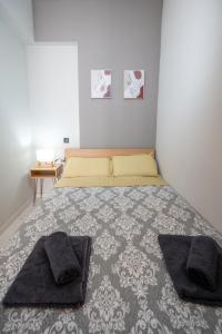 a bedroom with a bed with two pillows on it at Lazarus Central Home Ioannina in Ioannina