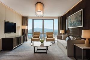 a living room with a couch and a table at Sheraton Zhuhai Hotel in Zhuhai