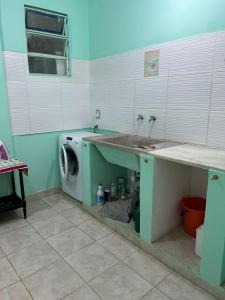 a laundry room with a sink and a washing machine at la florida C in Salta