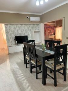 a dining room with a black table and chairs at la florida C in Salta