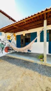 a hammock hanging from the side of a building at Quarto Sertão no Mar in Barra do Cunhau