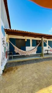 a hammock hanging from the side of a building at Quarto Sertão no Mar in Barra do Cunhau
