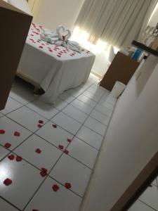 a room with a table with red roses on the floor at Ponta Negra Beach luxury hotel in Natal