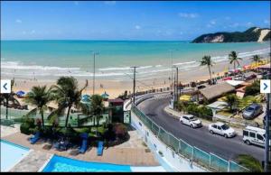 a view of a beach with cars parked on the road at Ponta Negra Beach luxury hotel in Natal