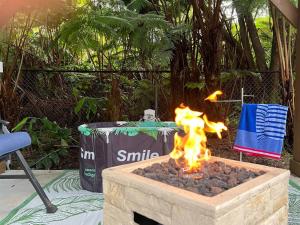 a fire pit in a yard with a fire at Romantic Retreat, Pop up Dome at your own private yard, Outdoor shower, firepit, 5 min to Hawaii Volcano park in Volcano