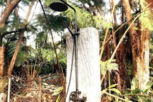 a stand up shower in the middle of a forest at Romantic Retreat, Pop up Dome at your own private yard, Outdoor shower, firepit, 5 min to Hawaii Volcano park in Volcano
