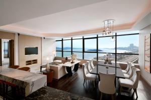 a living room with a table and chairs at Sheraton Qingdao West Coast in Huangdao