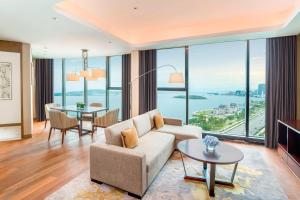 a living room with a couch and a table at Sheraton Qingdao West Coast in Huangdao