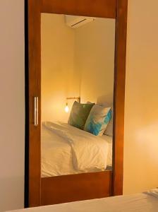 a mirror in a room with a bed and a bed sqor at Boca Simon Vacation Curacao in Willemstad