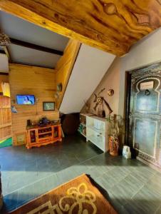 an attic room with a wooden ceiling and a living room at Auberge Dar Ruby 