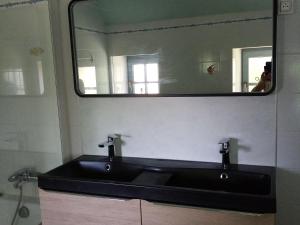 a bathroom with a black sink and a mirror at Gîte rénové en campagne, 3 ch., terrain 5000m², proche randonnées et Le Mans ! - FR-1-410-161 in La Chabossière +11 photos