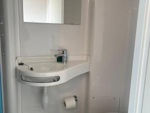 a bathroom with a white sink and a mirror at Séjour au Bord de l’eau - Moulin Authentique avec Pêche et Confort Moderne - FR-1-410-393 in Mézières-sur-Ponthouin +9 photos