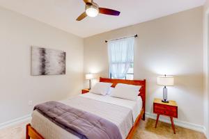 a bedroom with a bed and a ceiling fan at Yuba Oasis in Lely Resort +37 photos