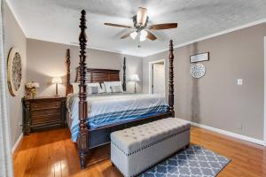 a bedroom with a bed and a ceiling fan at Liberty Port in Jefferson City
