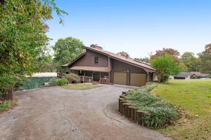 a house with a driveway in front of a yard at Liberty Port in Jefferson City