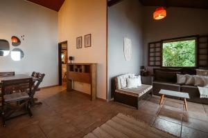 a living room with a couch and a table at CASA PARAISO full house rent with amazing sea view, Ilha Grande in Ilha Grande