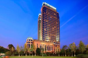 a tall building in front of a building at Sheraton Wenzhou Hotel in Wenzhou