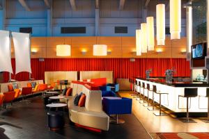 a restaurant with colorful chairs and a bar at Portsmouth Marriott Hotel in Portsmouth