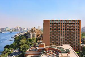 a tall building with a view of the water at Cairo Marriott Hotel & Omar Khayyam Casino in Cairo
