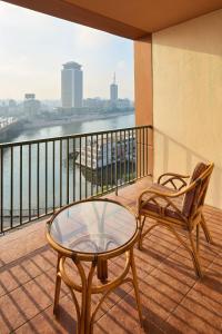 a balcony with two chairs and a glass table at Cairo Marriott Hotel & Omar Khayyam Casino in Cairo