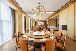 a large dining room with a large table and chairs at Suining Marriott Hotel in Suining
