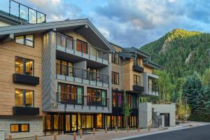 an apartment building with a mountain in the background at W Aspen in Aspen