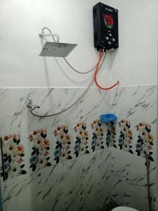 un baño con una pared con flores pintadas. en Mutiara Dieng en Wonosobo