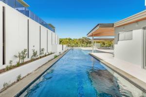 a swimming pool in the middle of a building at Oceanus Bokarina Beach in Kawana Waters