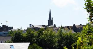 a view of a city with a spire in the background at Slaney Suites in Enniscorthy +12 photos