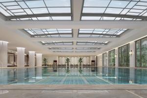 a large swimming pool in a building with a ceiling at Sheraton Yinchuan in Yinchuan