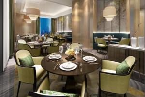 a dining room with tables and chairs and a restaurant at Four Points by Sheraton Wuhan, Jiangxia in Wuhan