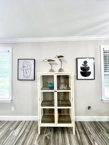 a white cabinet with two lamps in a room at *The Gem* Stylish 2 Bedroom 1 Bathroom Newly Renovated in Ladson