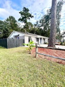 a small house with a fence and a tree at *The Gem* Stylish 2 Bedroom 1 Bathroom Newly Renovated in Ladson