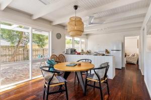 a kitchen and dining room with a table and chairs at Rosebud Hideaway - Cute Contemporary by the Beach in Rosebud