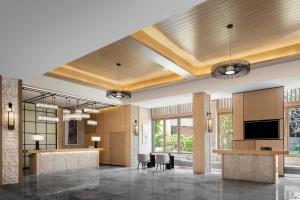a rendering of a lobby with a reception desk and chairs at Sheraton Maoming Romantic Beach Resort in Maoming
