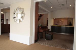 a lobby with a piano and a waiting room at Wortley House Hotel in Scunthorpe