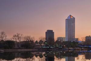 eine Skyline der Stadt mit einem hohen Gebäude im Hintergrund in der Unterkunft Liyang Marriott Hotel in Liyang