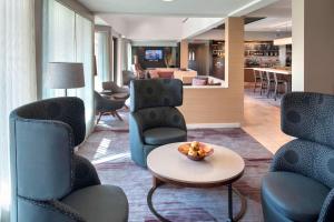 a hotel lobby with chairs and a table and a living room at Courtyard by Marriott Mt. Laurel in Mount Laurel