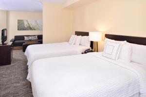 a hotel room with two beds and a couch at SpringHill Suites by Marriott Corona Riverside in Corona