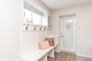 a home office with white walls and a window at Cozy Retreat with Hot Tub and Free Breakfast! in Lethbridge