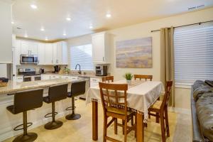 a kitchen with a table and chairs in a kitchen at Contemporary Home with Grill Near Utah Lake! in Saratoga Springs