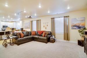 a living room with a couch and a kitchen at Contemporary Home with Grill Near Utah Lake! in Saratoga Springs