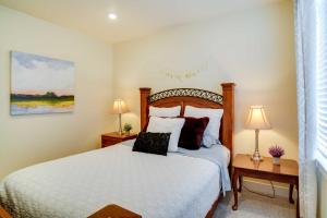 a bedroom with a white bed with two night stands and two lamps at Contemporary Home with Grill Near Utah Lake! in Saratoga Springs