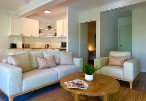 a living room with a couch and a table at Sunrise Beach Holiday Apartment in Sunrise Beach